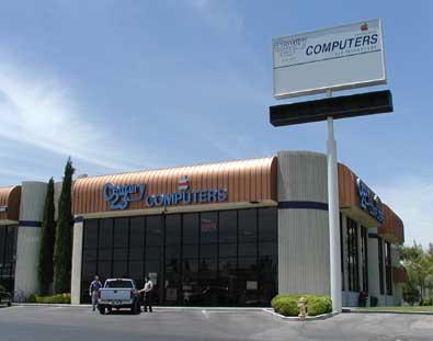 Picture of Meadows Lane building, large white glass fronted with copper soffet roof.